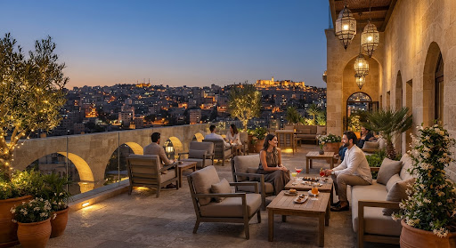 A boutique terrace above the glowing hills of Amman at dusk