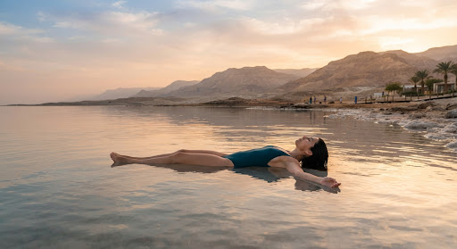 Floating in the still waters of the Dead Sea at golden hour